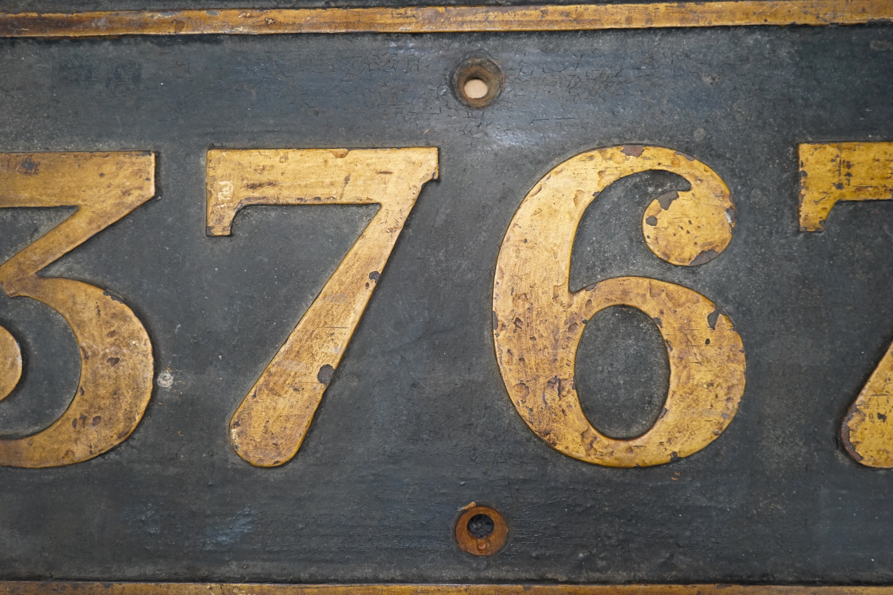 A cast iron GWR locomotive cab side number plate for a Class 57xx 0-6-0PT locomotive, 3767, built in 1937/38 at the Swindon Works, dimensions; 65cm x 30.5cm. Condition - fair to good, generally ex-loco condition with som